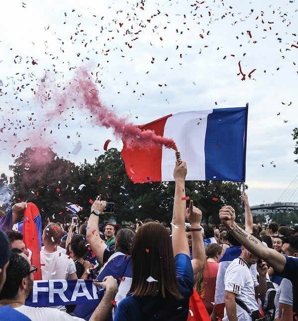 French flag and France supporters celebrating the World Cup win in 2018